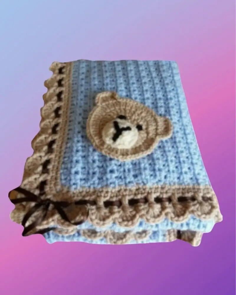 Handmade crochet baby blanket showing a sample bear appliqué. Customers can choose their favorite appliqué design.