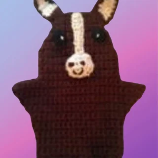Brown crocheted horse hand puppet with upright ears, white facial stripe and crocheted muzzle