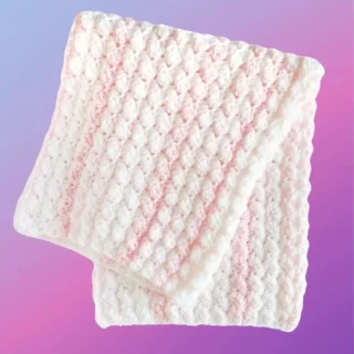 Handmade crochet baby blanket with textured stitch pattern