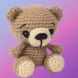 Crocheted Benji the Bear woodland critter sitting with tan muzzle and paws