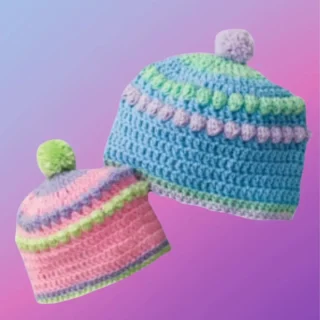 Handmade crochet baby bobble hat with decorative textured stitch design and pompom