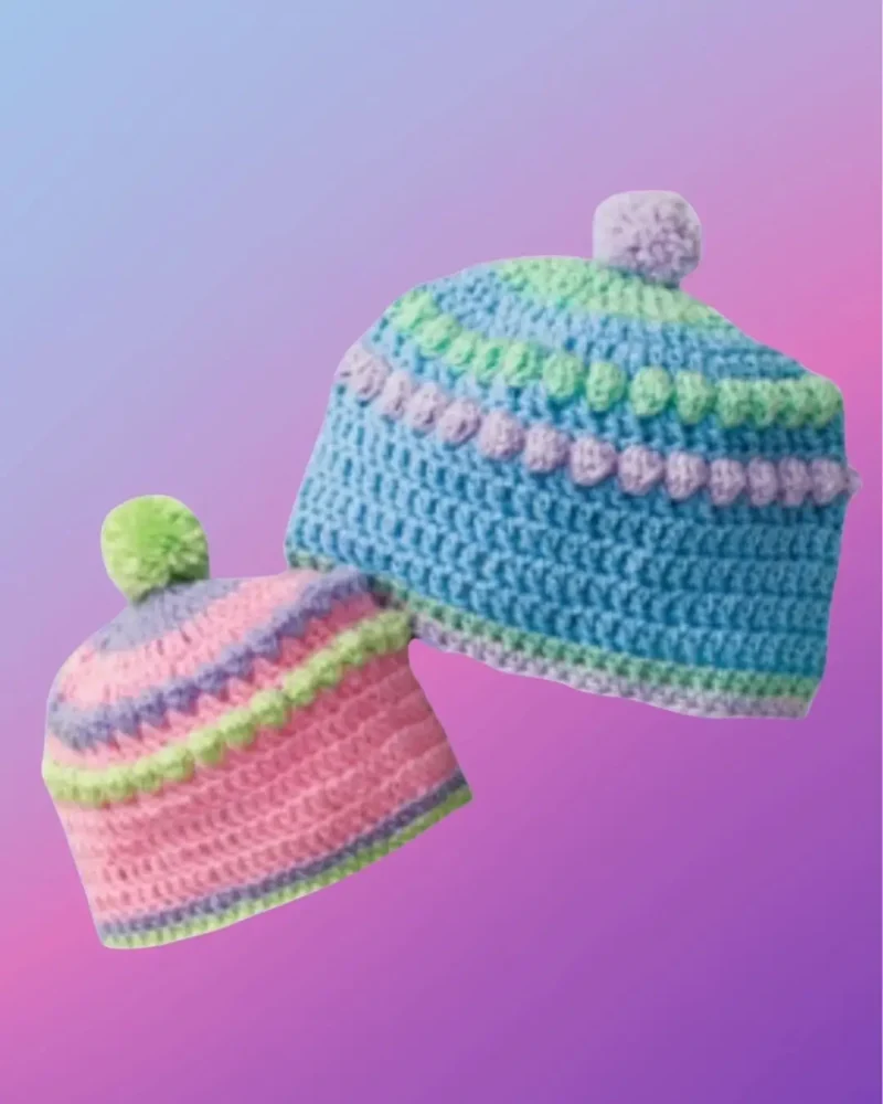 Handmade crochet baby bobble hat with decorative textured stitch design and pompom