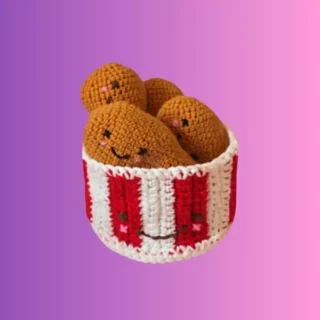 Crocheted bucket filled with smiling chicken drumstick toys