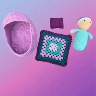 Crocheted cradle purse with matching blanket and drawstring-style closure