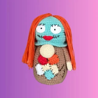 Handmade crochet patchwork doll stash container with long yarn hair and stitched details