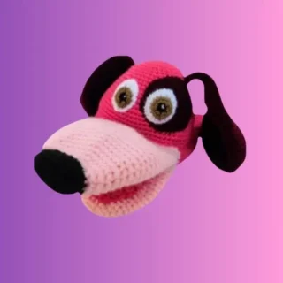 Pink and brown crocheted dog hand puppet with large muzzle and floppy ears