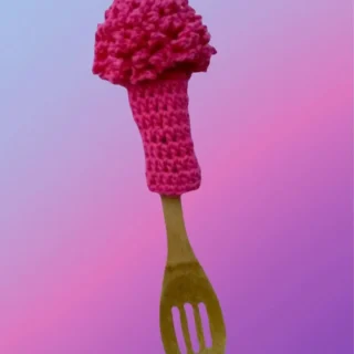 Handmade crochet glass scrubber displayed on a wooden spoon handle