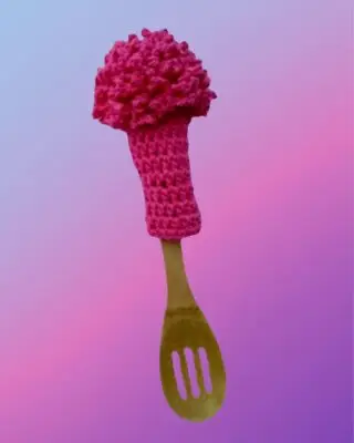 Handmade crochet glass scrubber displayed on a wooden spoon handle