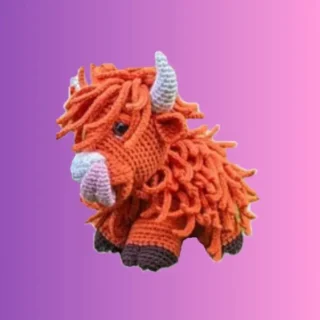 Handmade crochet Highland cow amigurumi with individually crocheted shaggy hair and horns