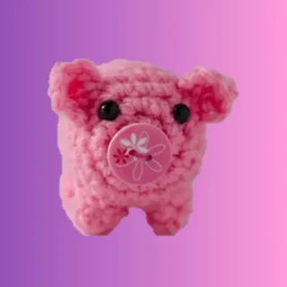 Handmade pink crochet little pig amigurumi with button snout