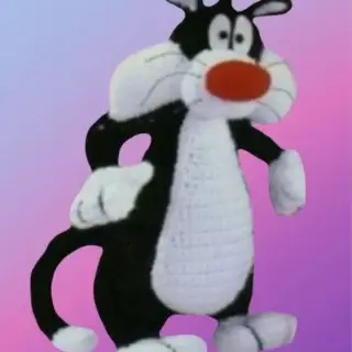 Handmade crochet Mischievous Tuxedo Cat with red nose and chubby cheeks.