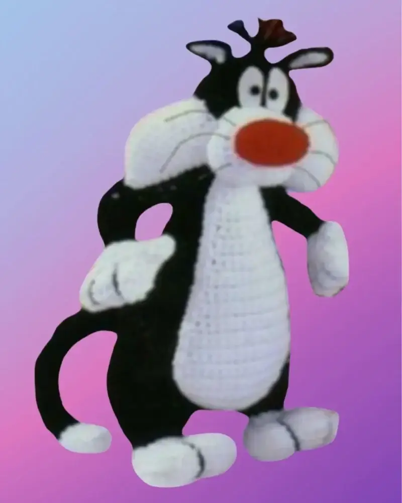 Handmade crochet Mischievous Tuxedo Cat with red nose and chubby cheeks.