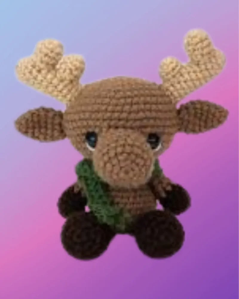 Crocheted Myles the Moose woodland critter with large antlers and green scarf