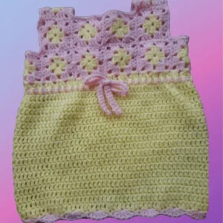 Handmade crochet newborn dress with granny square top and scalloped edging