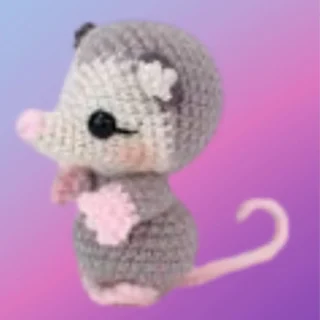 Crocheted Poise the Possum woodland critter with gray body, pink details and curled tail