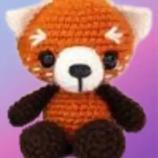 Crocheted Riley the Red Panda woodland critter with rust, white and dark brown details