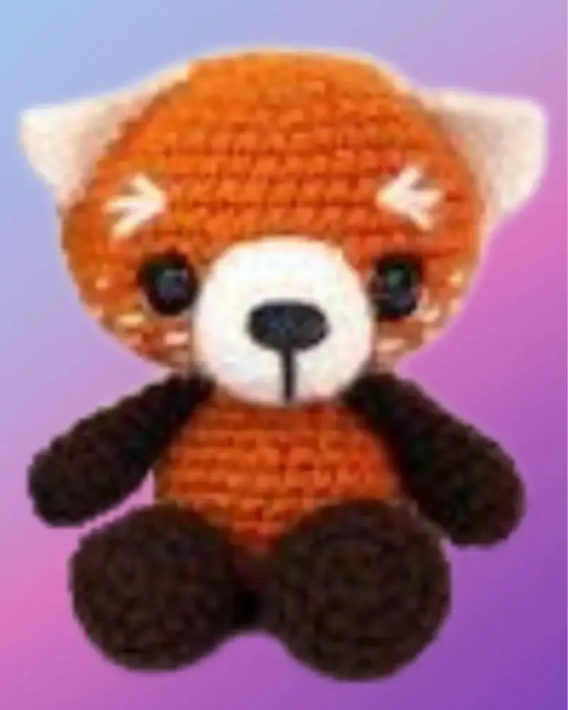 Crocheted Riley the Red Panda woodland critter with rust, white and dark brown details