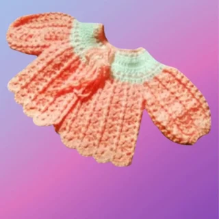 Handmade crochet baby sweater with shell stitch design and puff sleeves