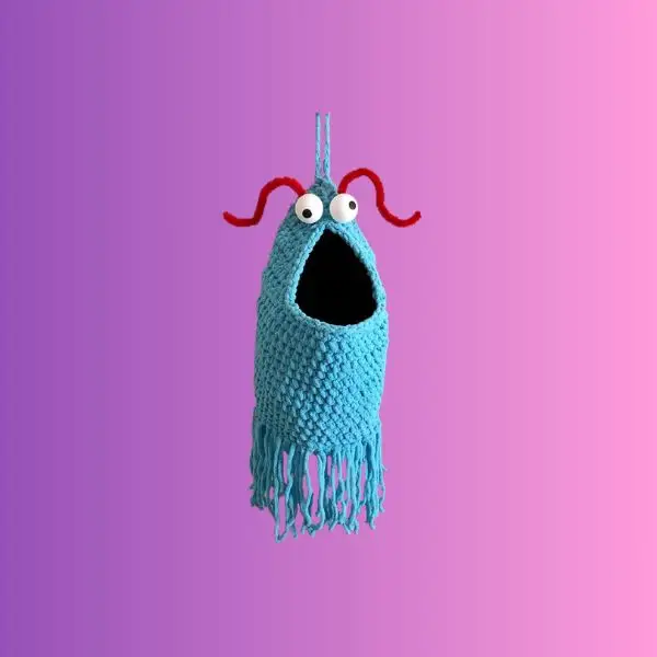 Handmade crochet silly alien plastic shopping bag holder with large eyes and fringe
