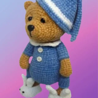 Handmade crochet Sleeping Teddy Bear in Pajamas with removable nightcap and bunny slippers.