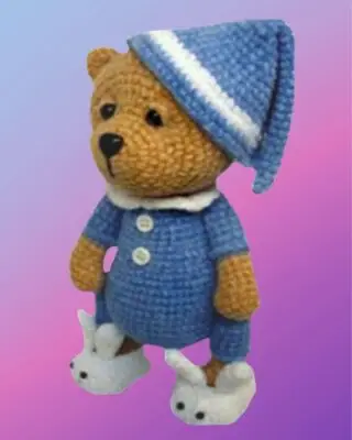 Handmade crochet Sleeping Teddy Bear in Pajamas with removable nightcap and bunny slippers.