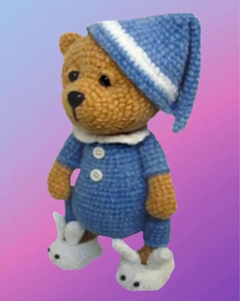 Handmade crochet Sleeping Teddy Bear in Pajamas with removable nightcap and bunny slippers.
