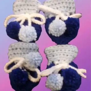 Set of four crocheted booties with ties for small dogs