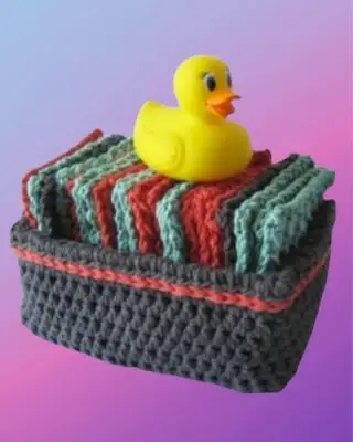 Handmade crochet washcloths arranged in a matching crochet basket