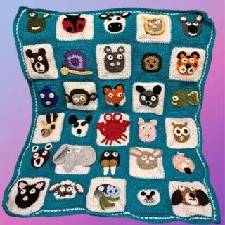 Handmade crochet Zookeeper Blanket with individually crocheted animal faces sewn onto squares